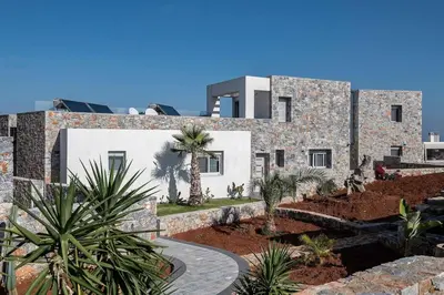 a stone building with a palm tree in front of it at Aloni Villa with pool Kefalas in Vamos