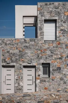 a stone building with two doors and two windows at Aloni Villa with pool Kefalas in Vamos