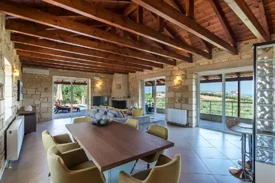 a large living room with a wooden table and chairs at Villa Chara Chania in Agia Marina Nea Kydonias