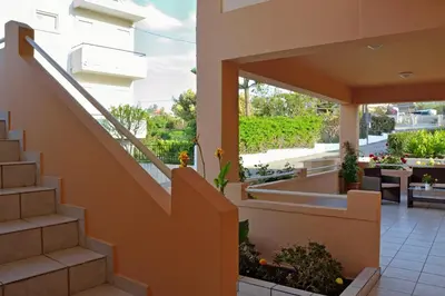 a staircase leading up to a house with a patio at Sofoklis Apts in Stalos