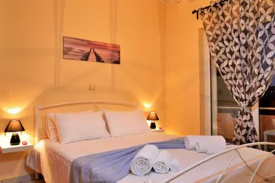 a bedroom with a bed with towels on it at Sofoklis Apts in Stalos