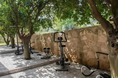 a row of exercise bikes parked next to a stone wall at Villa Casa di Verde in Patellárion