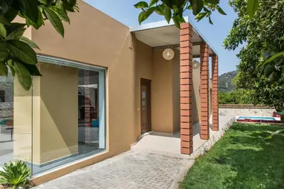a home with a glass door and brick columns at Villa Casa di Verde in Patellárion