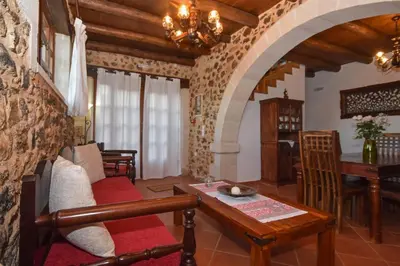 a living room with a couch and a table at Aretaki villas in Astrátigos
