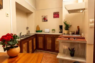 a kitchen with a sink and a vase of flowers on a table at Iason Studios in Chania Town