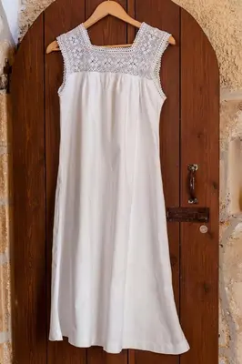 a white dress hanging on a wooden door at Hamam Suites Sifaka in Chania Town