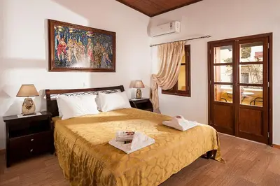a bedroom with a large bed and a window at Hamam Suites Sifaka in Chania Town