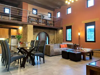 a living room with a table and a couch at Archon Villa in Pandeleḯmon
