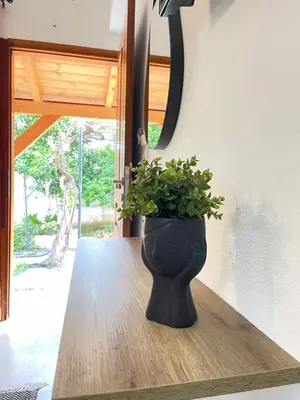 a black vase sitting on a table with a plant at Katerina Sea Apartments in Chania Town