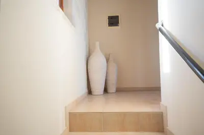 two vases sitting on the side of a staircase at Villa Petra- Panormic Sea view - Private Pool in Kalyves