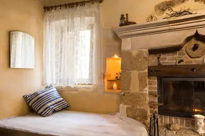 a living room with a fireplace and a window at Villa Margot in Chania Town