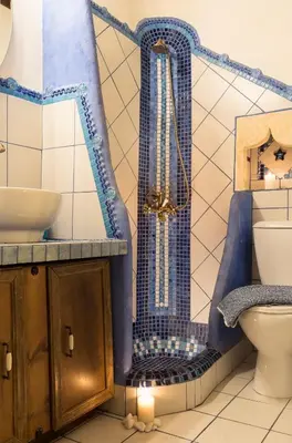 a bathroom with a blue and white tub next to a toilet at Villa Margot in Chania Town