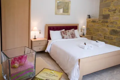 a bedroom with a bed with a fish tank on a table at Agarathos Tradiitonal Apartments & Rooms with Pool Kaliviani -On the road to Balos in Kissamos