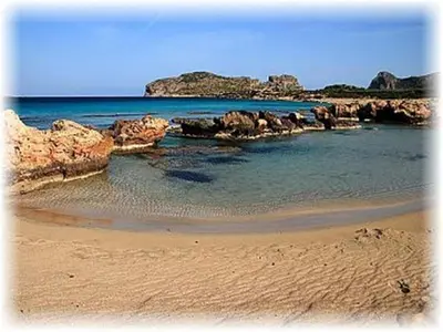 a beach with rocks in the water and the ocean at Studio in Ravdoucha with Sea View Balcony in Ravdhoúkha