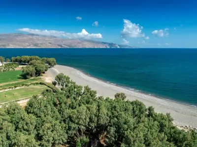 an aerial view of a beach with trees and the ocean at Studio in Ravdoucha with Sea View Balcony in Ravdhoúkha