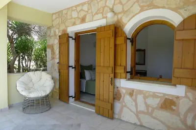 a room with a mirror and a chair on a patio at Villa Rodi in Gavalochori