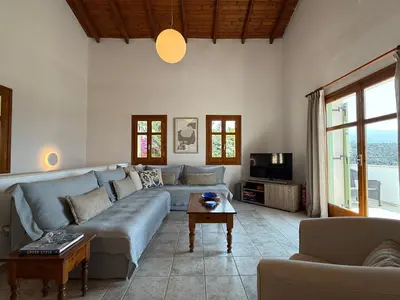 a living room with a couch and a tv at Villa Rodi in Gavalochori