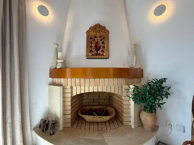 a room with a brick fireplace with a picture on the wall at Villa Rodi in Gavalochori