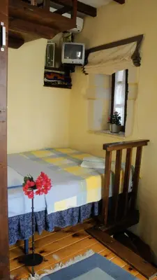 a small bedroom with a bed in a room at Old Stone House in Chania Town
