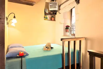 a bedroom with a bed with a hat on it at Old Stone House in Chania Town