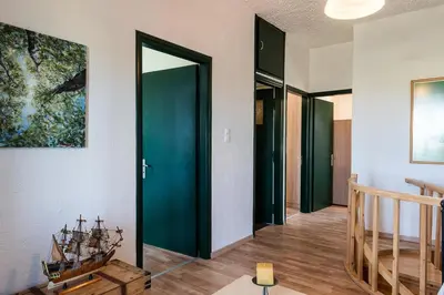 a hallway with a door with a boat on the wall at Traditional Sea Side Cottage in Maleme