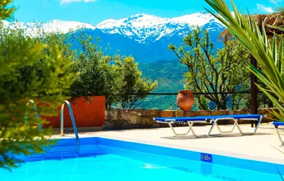 a swimming pool with a view of mountains at Anna-Malai Penthouse in Megála Khoráfia