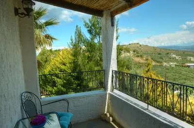 a balcony with a view of the mountains at Anna-Malai Penthouse in Megála Khoráfia