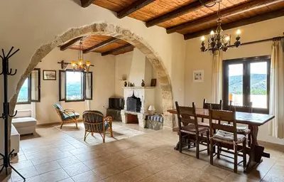 a kitchen and dining room with a table and chairs at Anna-Malai Penthouse in Megála Khoráfia