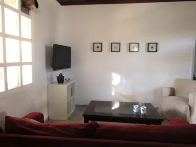 a living room with a couch and a tv at Trouli House in Stalos