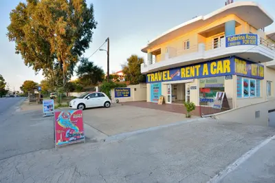 a car is parked in front of a building at Katerina Rooms Agii Apostoloi in Kato Daratso