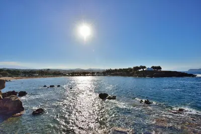 a body of water with the sun in the sky at Katerina Rooms Agii Apostoloi in Kato Daratso