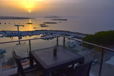 a table on a balcony with a view of a marina at Panoramic Sea View in Chania Town