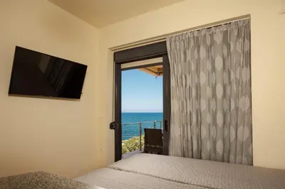 a bedroom with a window with a view of the ocean at Panoramic Sea View in Chania Town