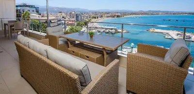 a balcony with a table and chairs and a view of the water at Panoramic Sea View in Chania Town