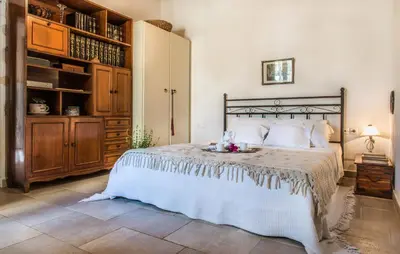 a bedroom with a bed with a plate of fruit on it at Petra & Elia in Megála Khoráfia