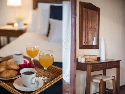 a hotel room with a bed and a tray of food and drinks at Antheia Houses in Vamos