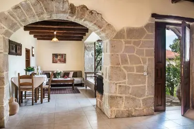 an archway in a living room with a table and chairs at Antheia Houses in Vamos