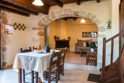a kitchen and dining room with a table and chairs at Antheia Houses in Vamos