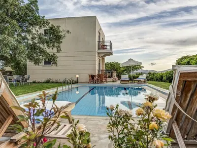 a swimming pool in the backyard of a house at Villa Kalliani in Kissamos