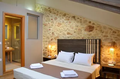 a bedroom with a bed with two towels on it at Elia Kentron in Chania Town