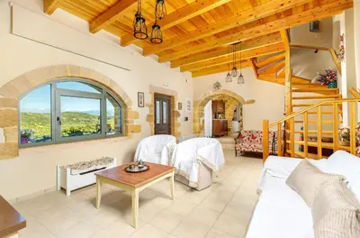 a living room with a couch and a table at Villa Panareti in Kolymvari