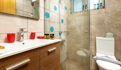 a bathroom with a toilet and a sink and a shower at Villa Panareti in Kolymvari