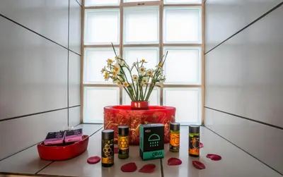 a table with a vase with flowers and cosmetics at Villa Panareti in Kolymvari