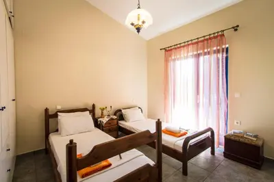 a bedroom with two beds and a window at Mantilida Villa & Studio in Kissamos