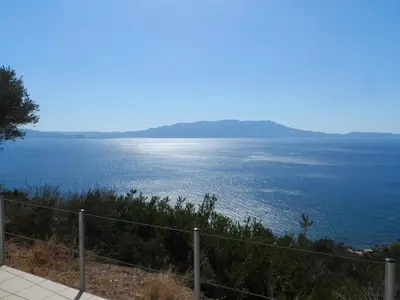 a view of the ocean from a hill at Michalis Holiday Home in Ravdhoúkha