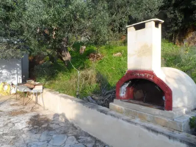 a brick oven sitting on top of a wall at Michalis Holiday Home in Ravdhoúkha