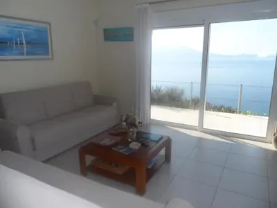 a living room with a couch and a coffee table at Michalis Holiday Home in Ravdhoúkha