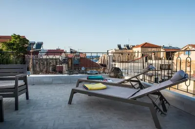 a patio with a table and chairs on a balcony at Casa Maritima in Chania Town