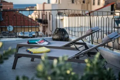 a table on top of a balcony with a view at Casa Maritima in Chania Town