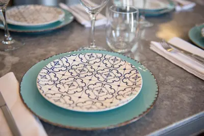 a plate sitting on top of a table with glasses at Casa Maritima in Chania Town